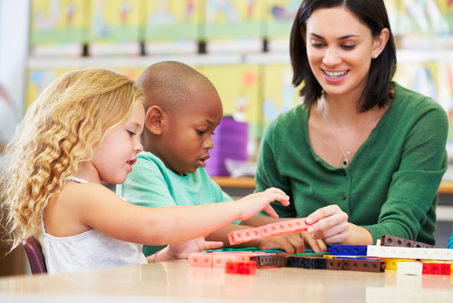 teacher with  two young children in class