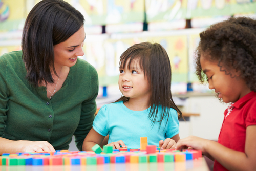 teacher with  two young children in class
